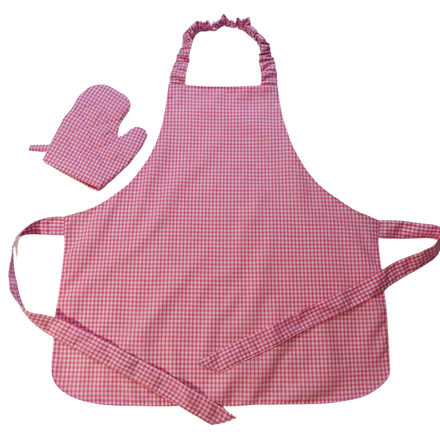 A pink gingham apron and oven mitt play set for children laid out on a white background.