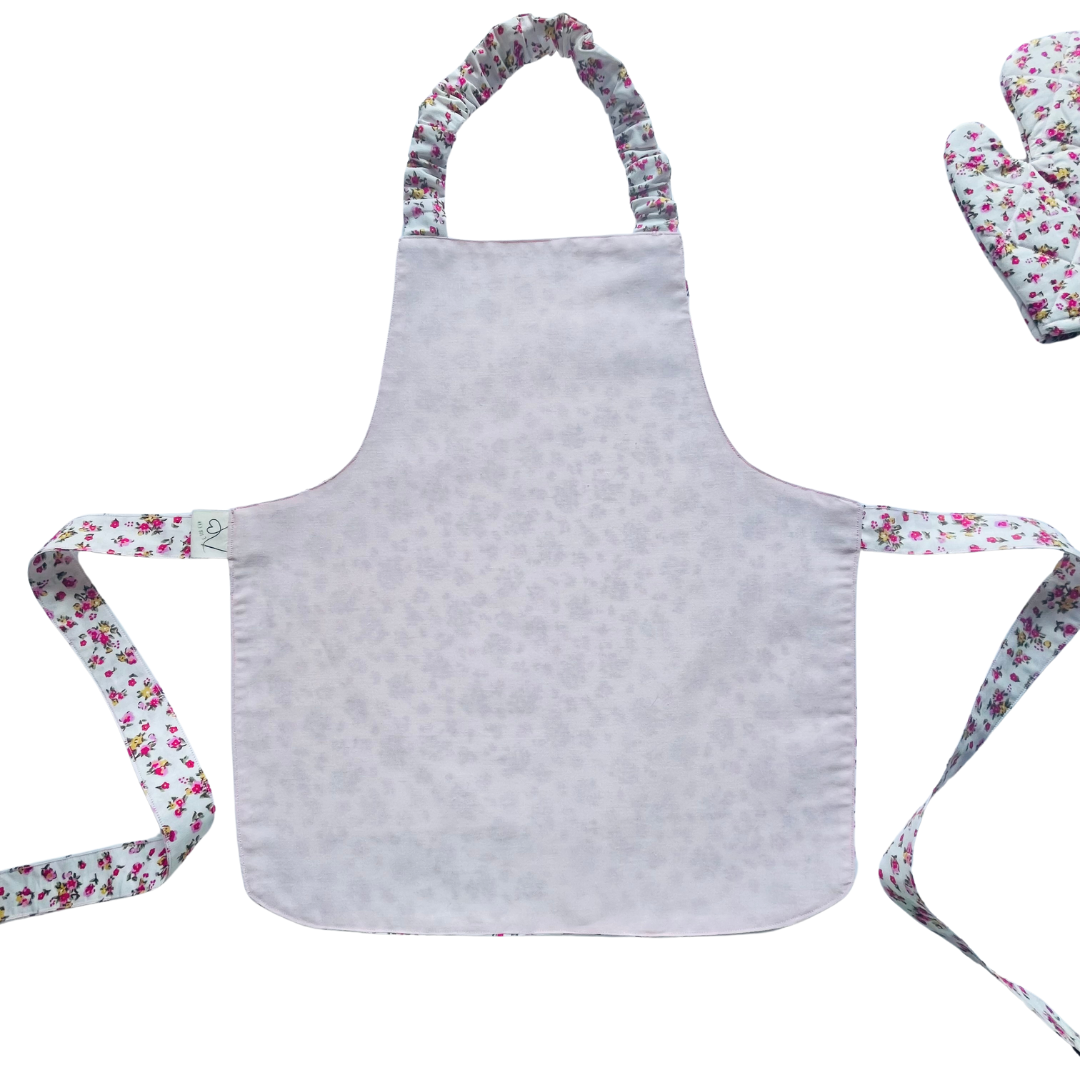 A toddlers apron and matching oven mitt set. Pattern is white with pink and yellow dainty flowers all over.