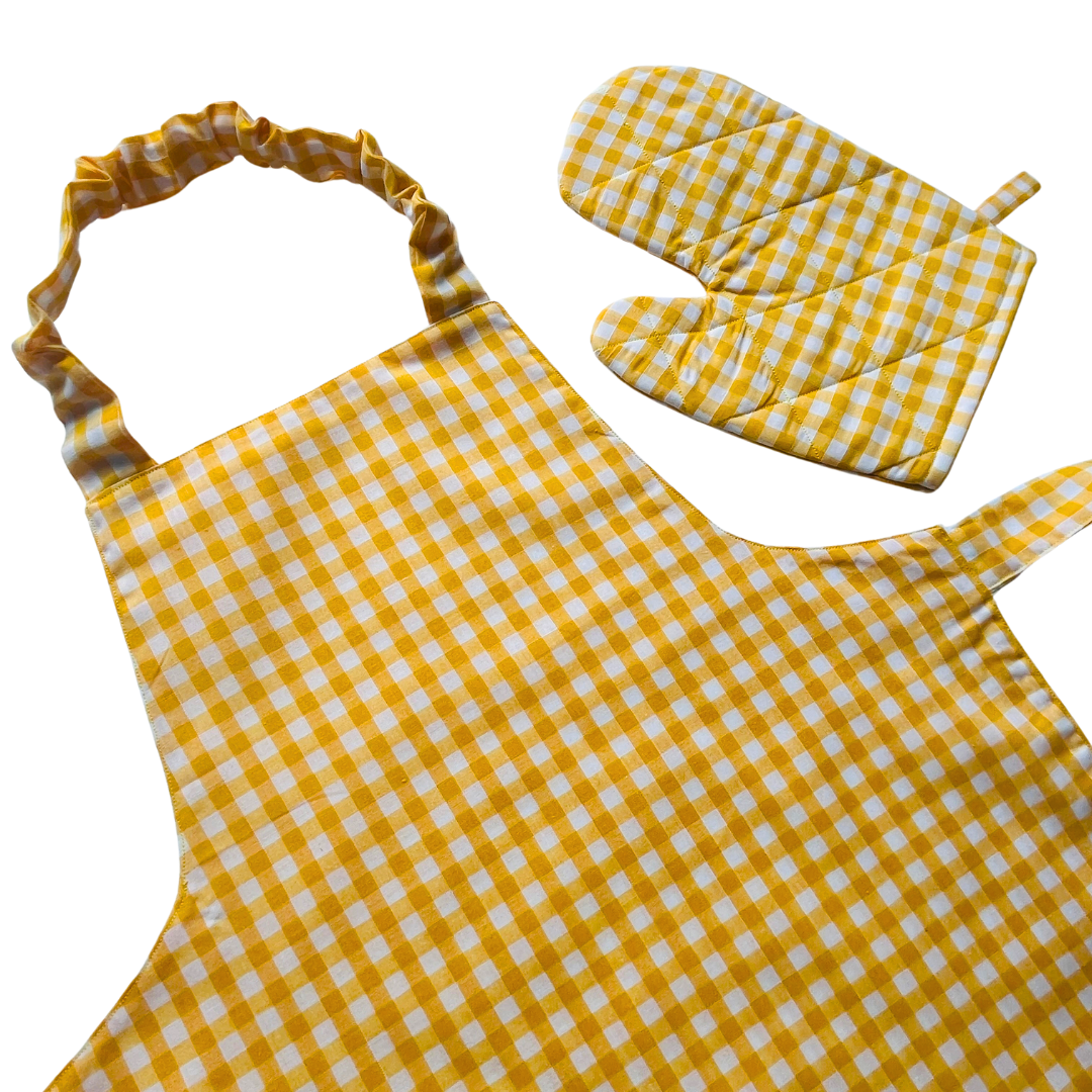 A child’s apron and matching oven mitt set. Pattern is yellow and white gingham.