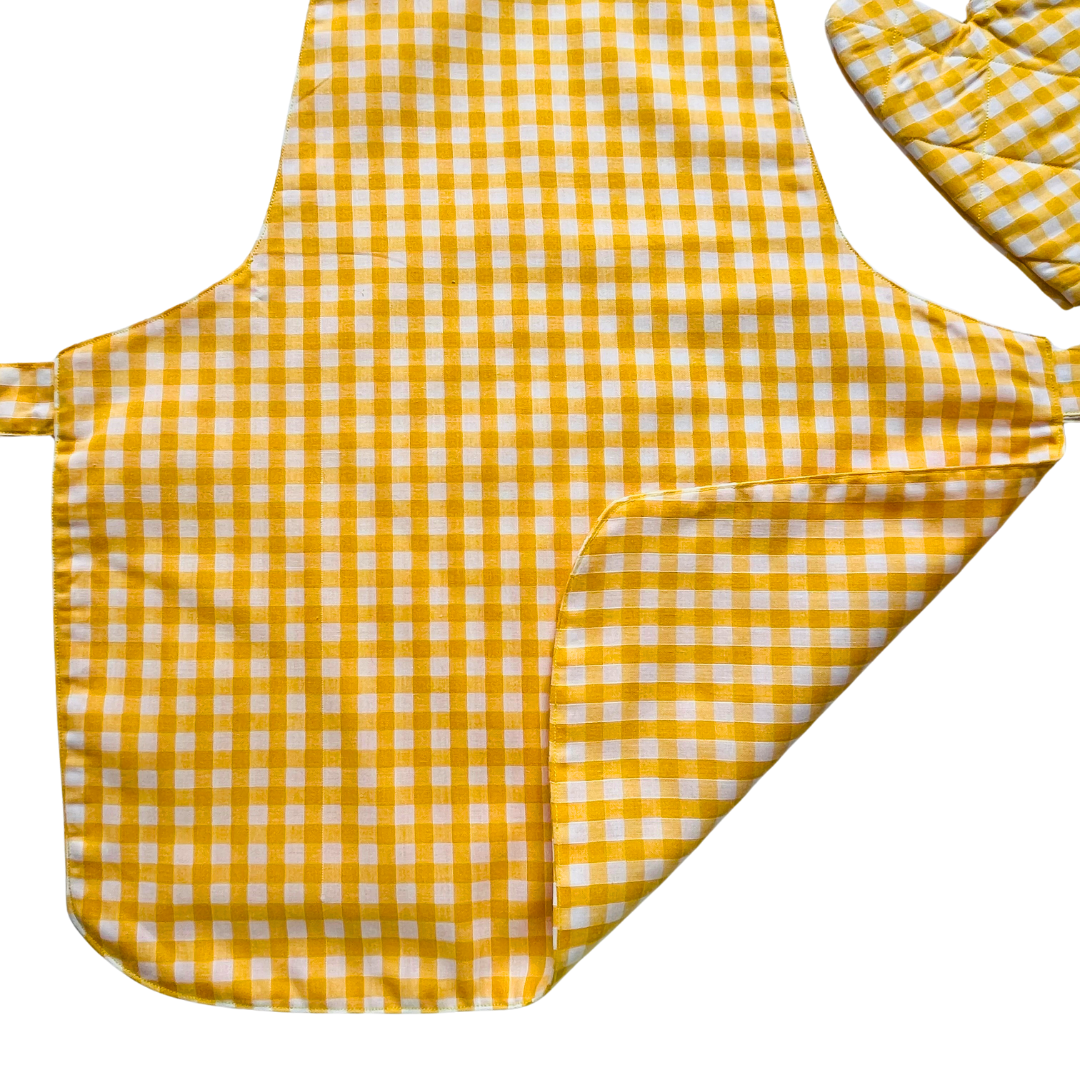 A child’s apron and matching oven mitt set. Pattern is yellow and white gingham.