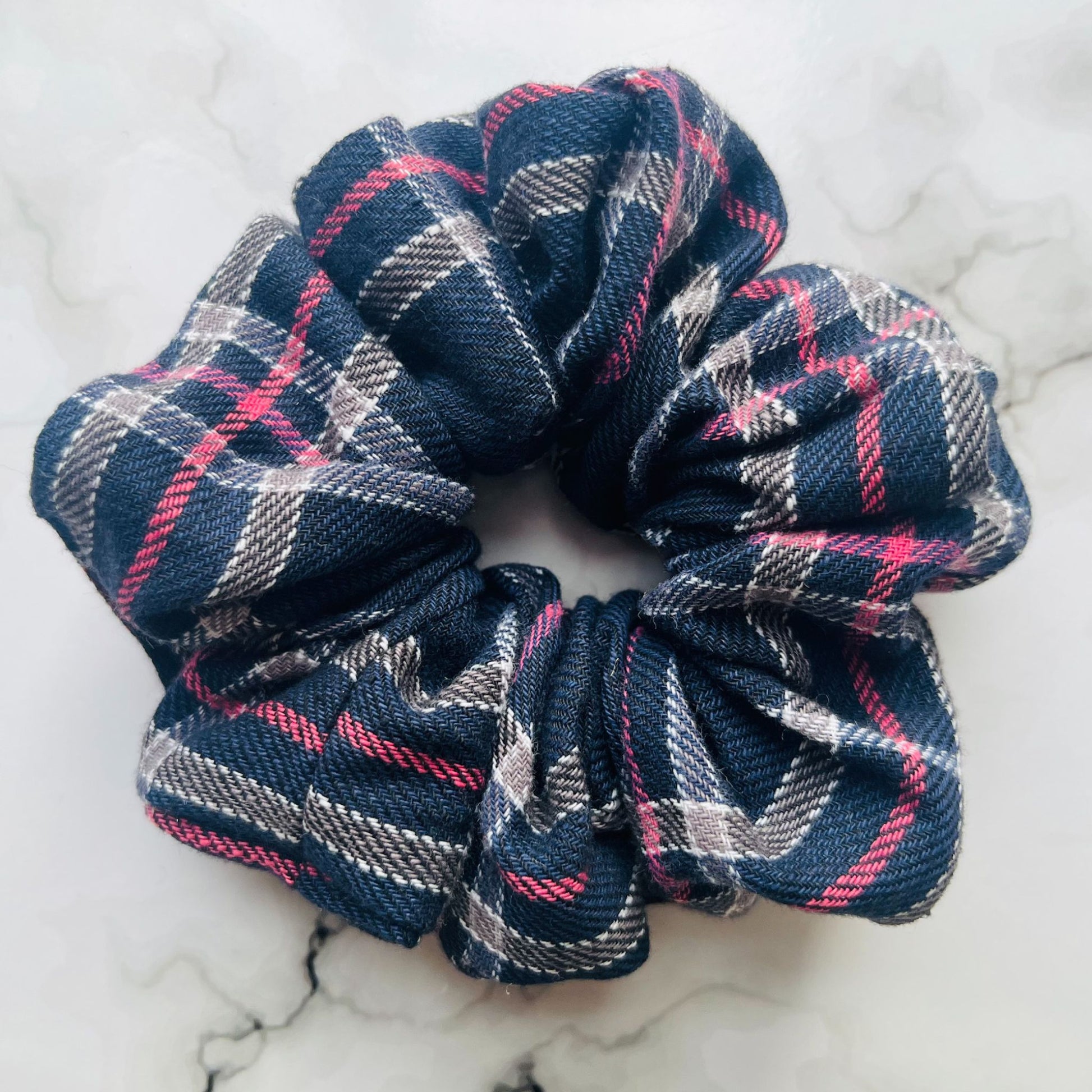 Close up of blue tartan hair scrunchie cotton E for Eva
