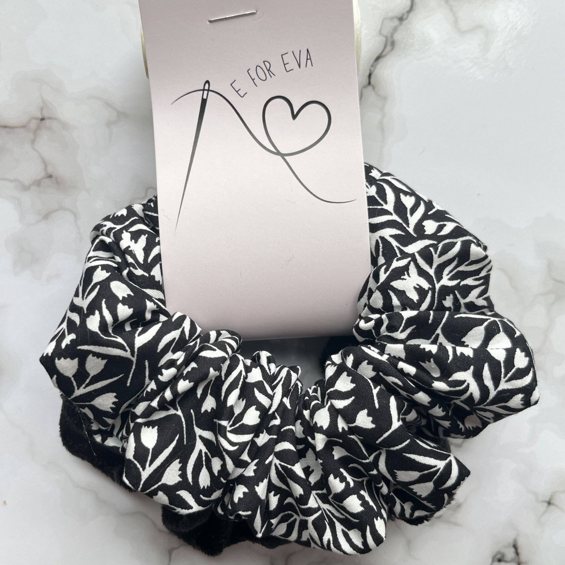 Tagged view of black and white floral hair scrunchies cotton velvet E for Eva