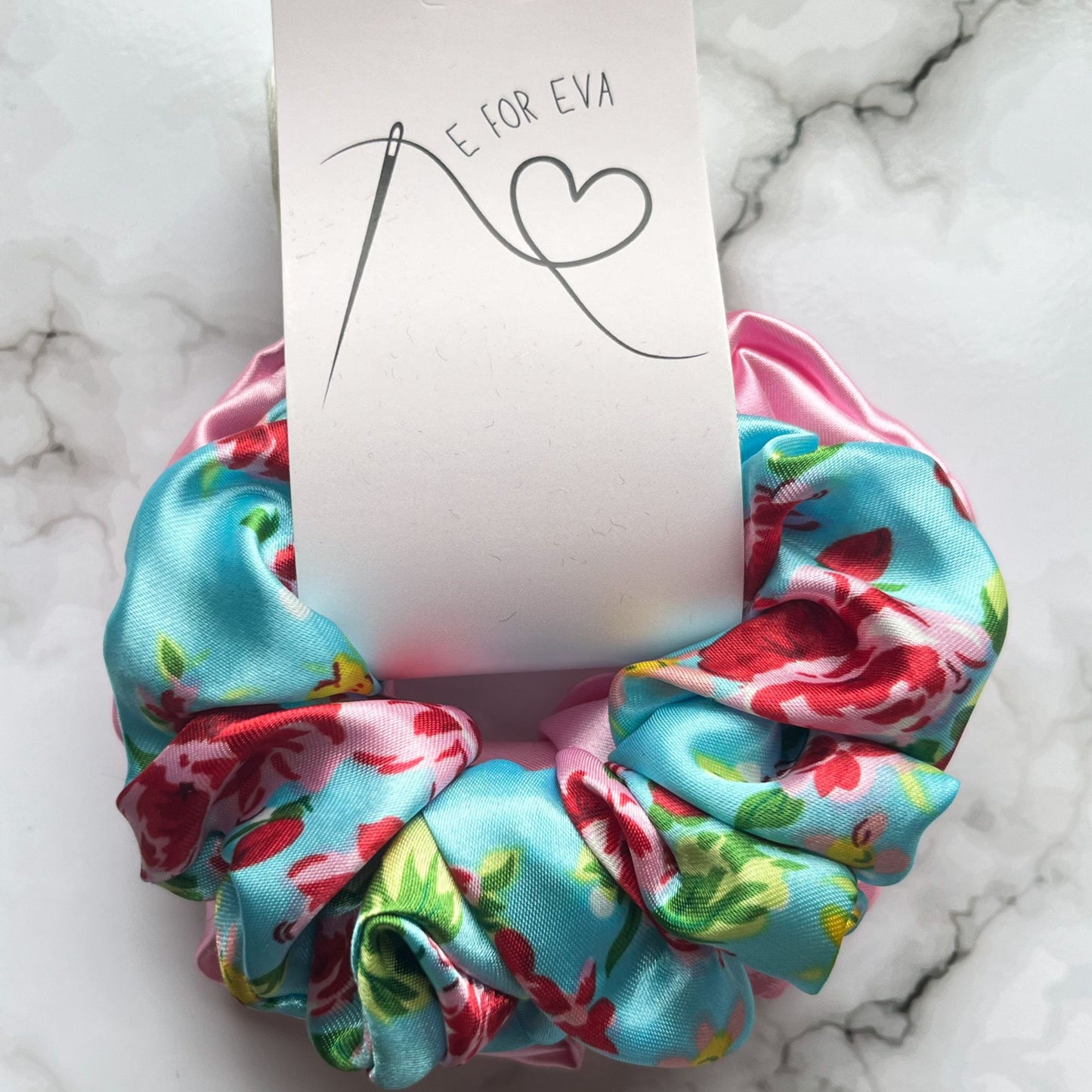 Tagged view of blue floral and pink hair scrunchies satin E for Eva