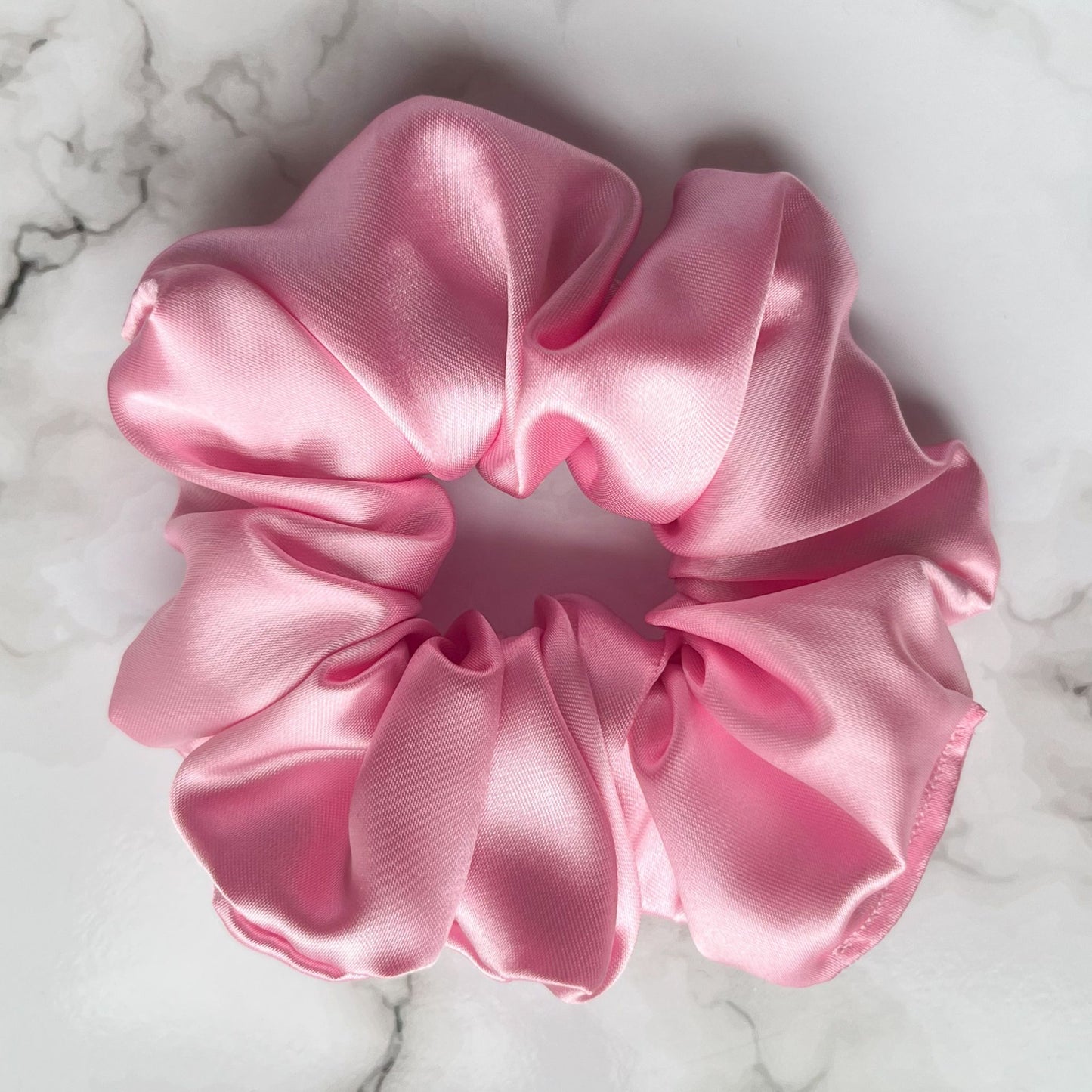 Close up of pink hair scrunchie satin E for Eva