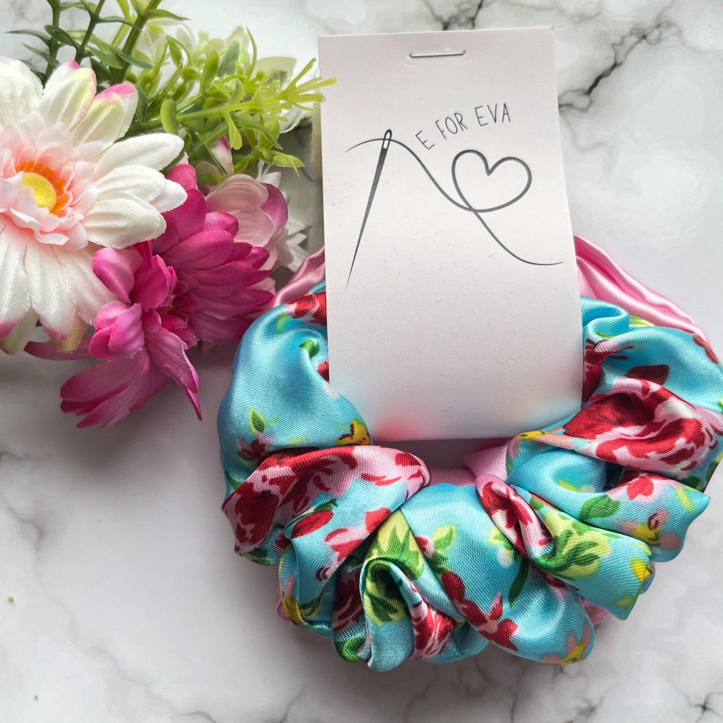 Styled tagged view of blue floral and pink scrunchies satin E for Eva