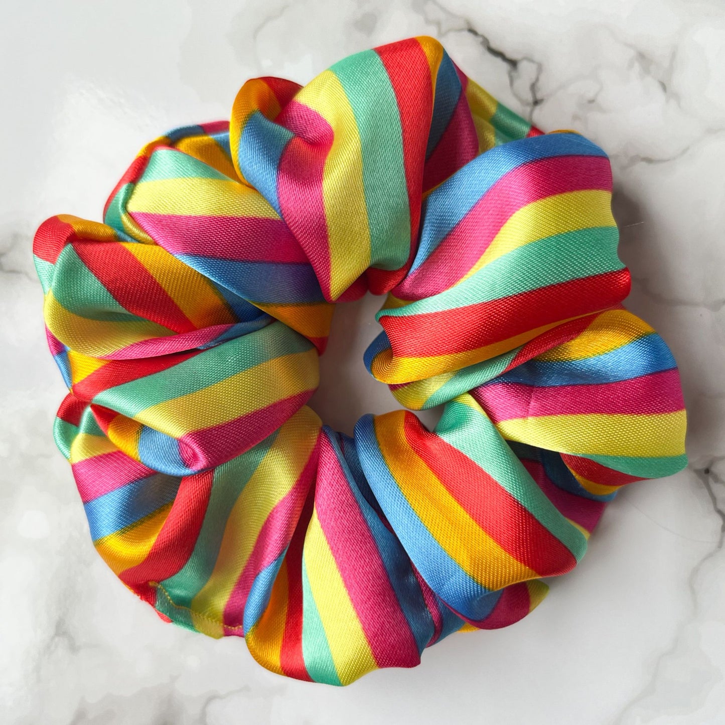 Close up of stripes rainbow hair scrunchie satin E for Eva