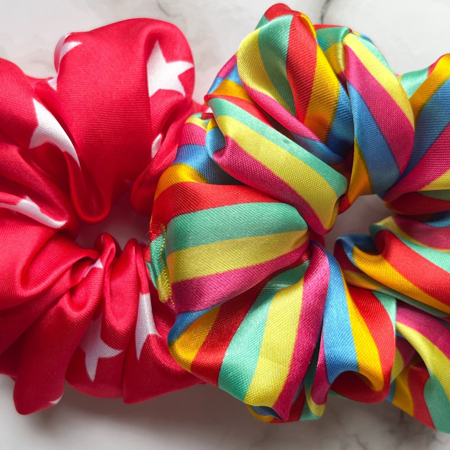 close up of circus stripes stars rainbow hair scrunchies satin E for Eva