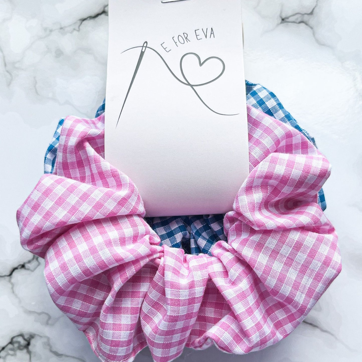 Tagged view of pink and blue gingham hair scrunchies cotton E for Eva