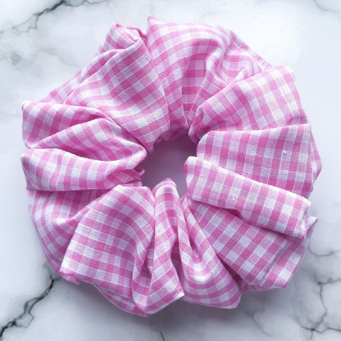 Close up of pink gingham hair scrunchie cotton E for Eva