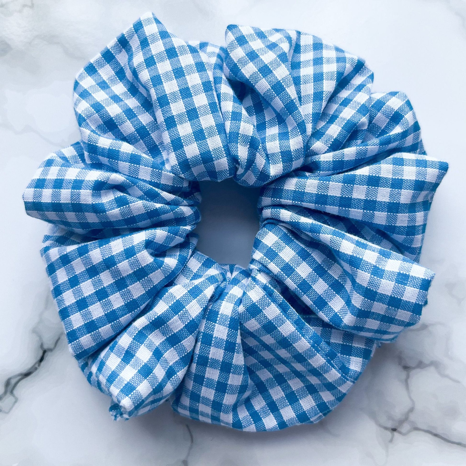 Close up of blue gingham hair scrunchie cotton E for Eva