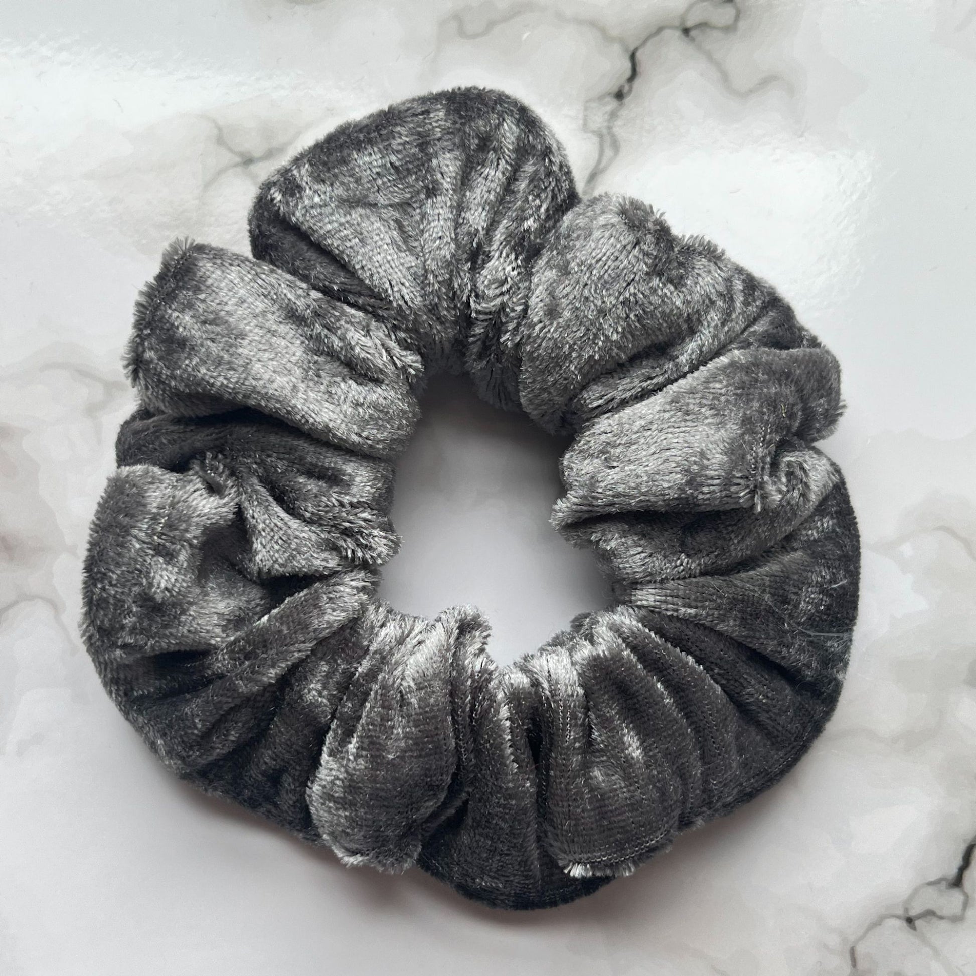 Close up of silver hair scrunchie velvet E for Eva