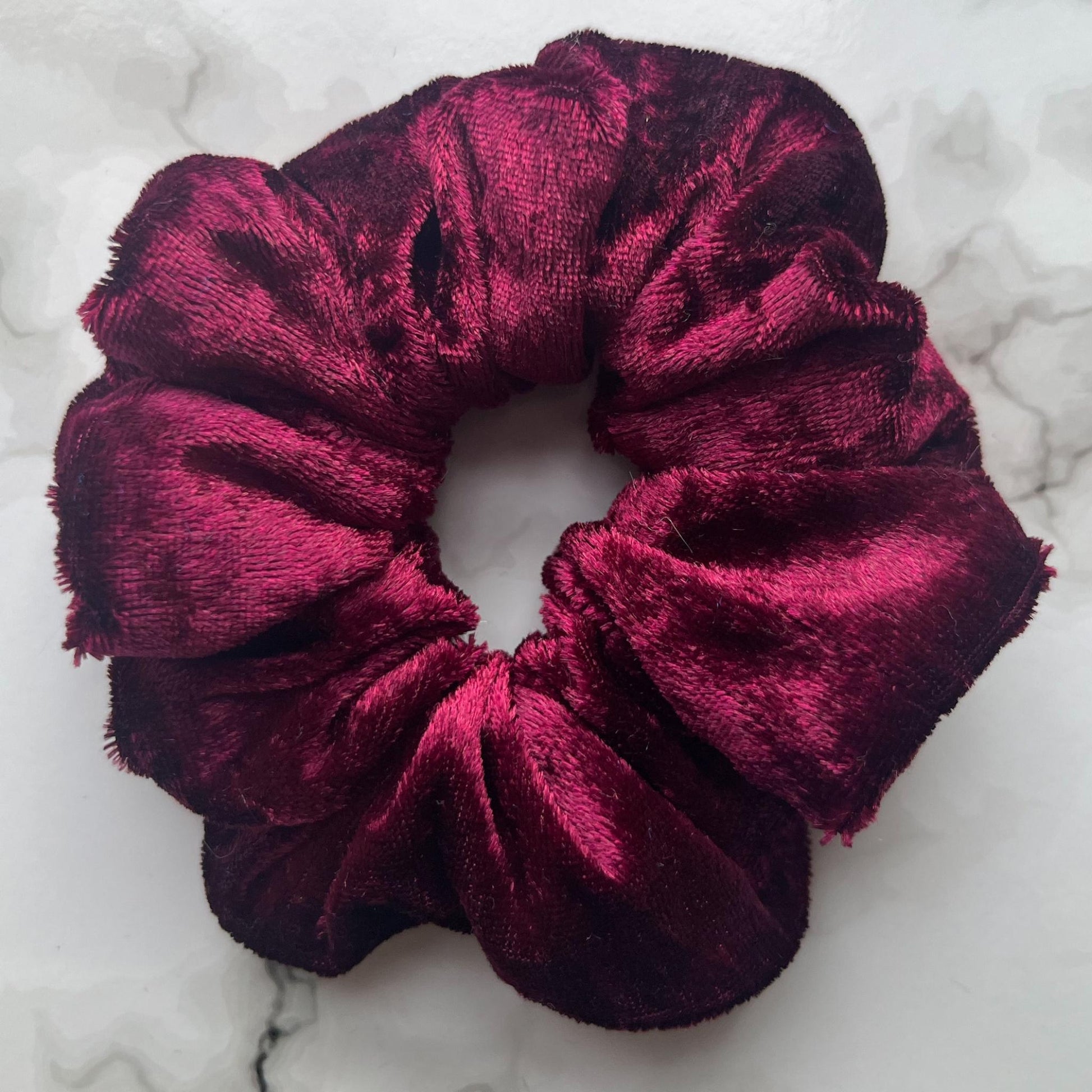 Close up of red hair scrunchie velvet E for Eva