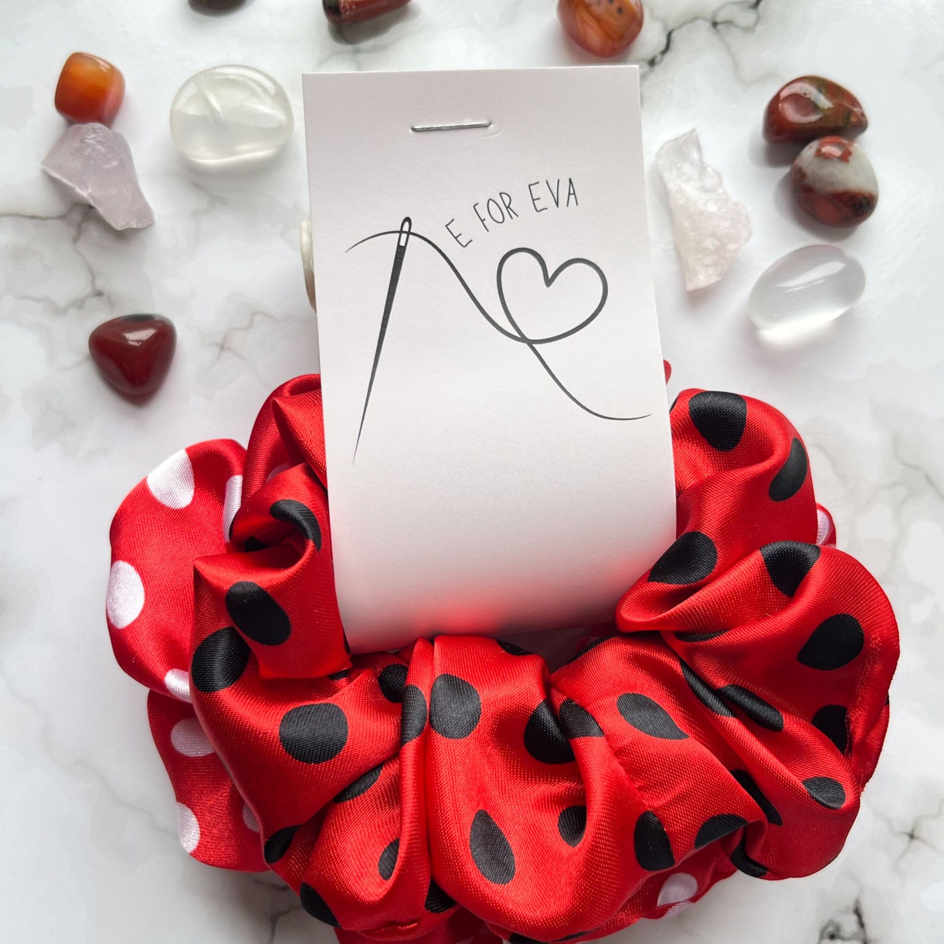 Styled tagged view of red black and white spots hair scrunchies satin E for Eva