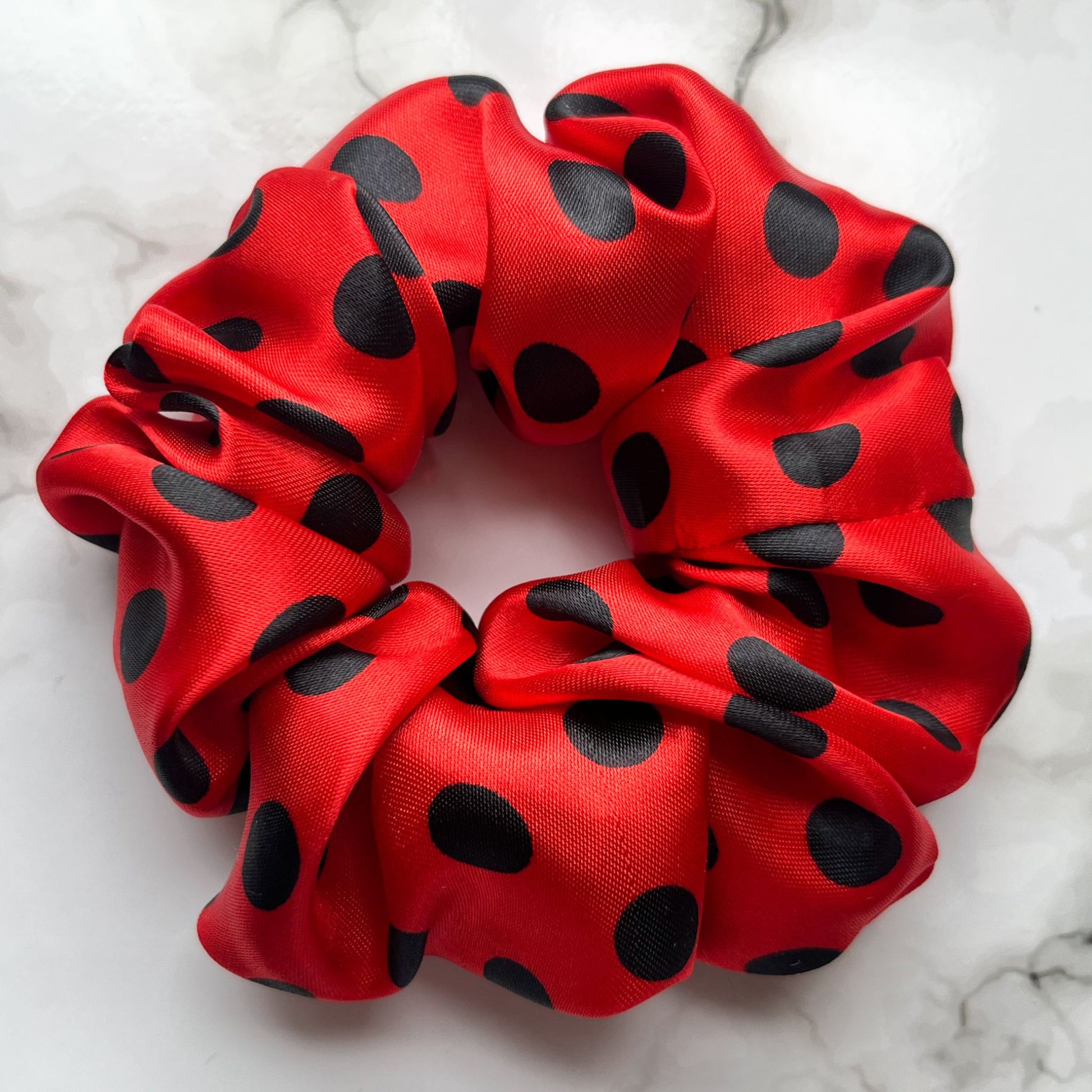 Close up to red and black spots hair scrunchie satin E for Eva