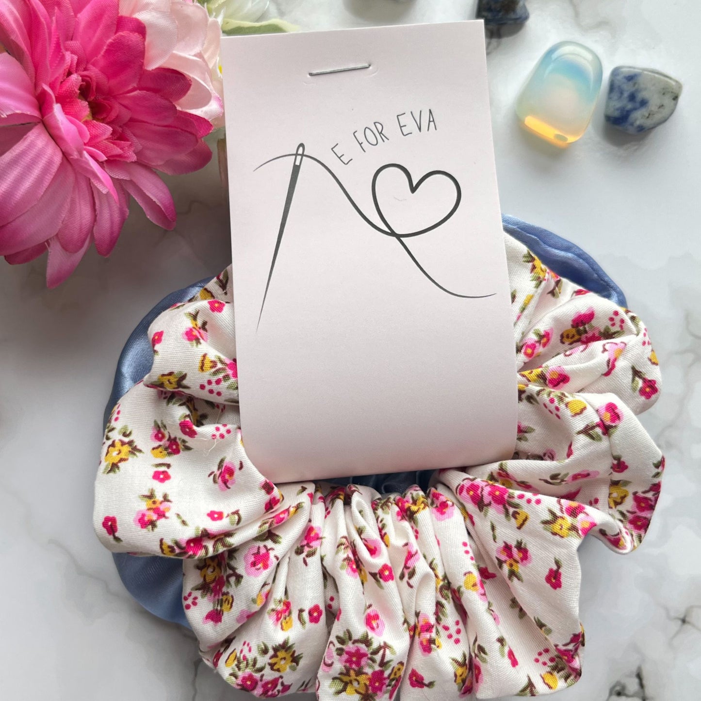 Styled tagged view of blue and pink floral hair scrunchies cotton satin E for Eva