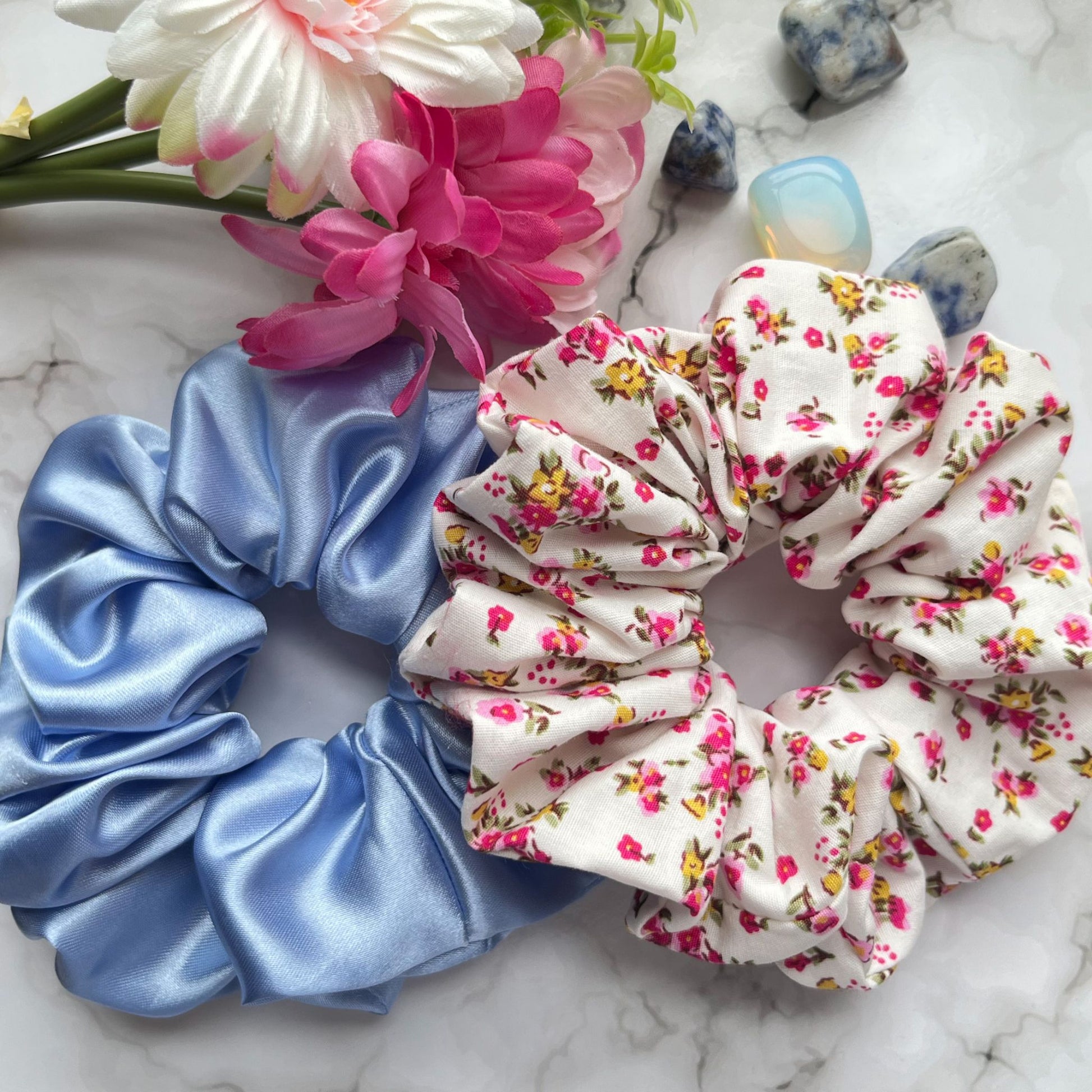 Styled overview of pink floral and blue hair scrunchies satin cotton E for Eva