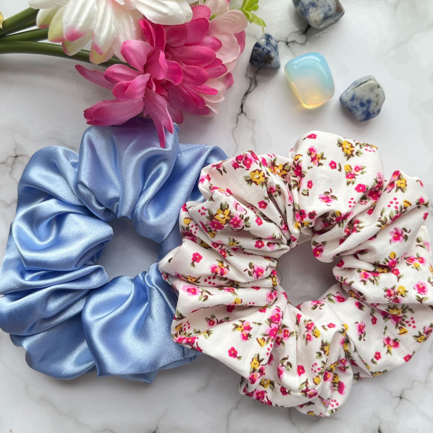 Styled overview of blue and pink floral hair scrunchies cotton satin E for Eva
