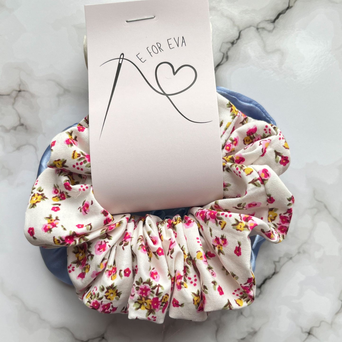Tagged view of blue and pink floral hair scrunchies cotton satin E for Eva