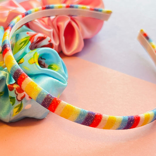 Styled shot of rainbow striped headband E for Eva