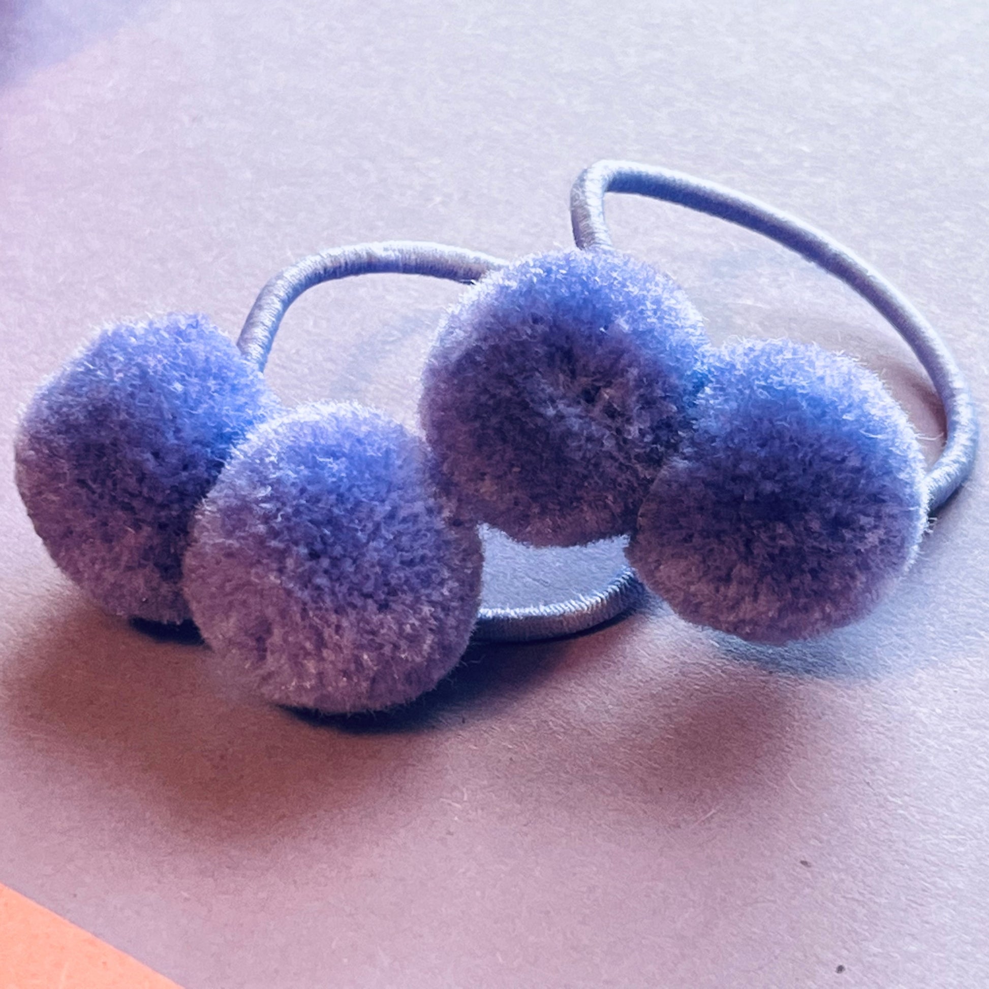 Purple pompom hair ties E for Eva