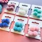 Tagged shot of pompom hair elastics E for Eva