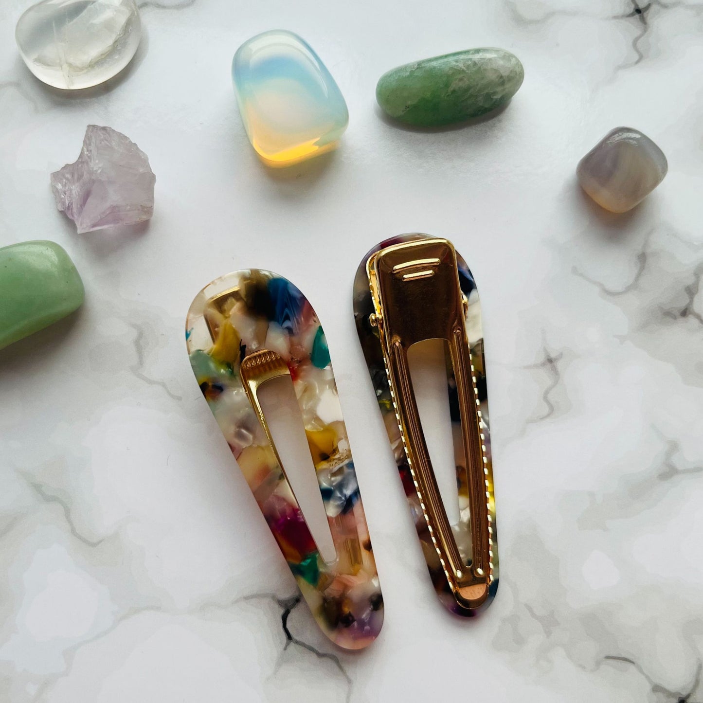 Styled overview of white geometric hair clips E for Eva
