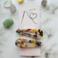 Styled tagged view of white geometric hair clips E for Eva