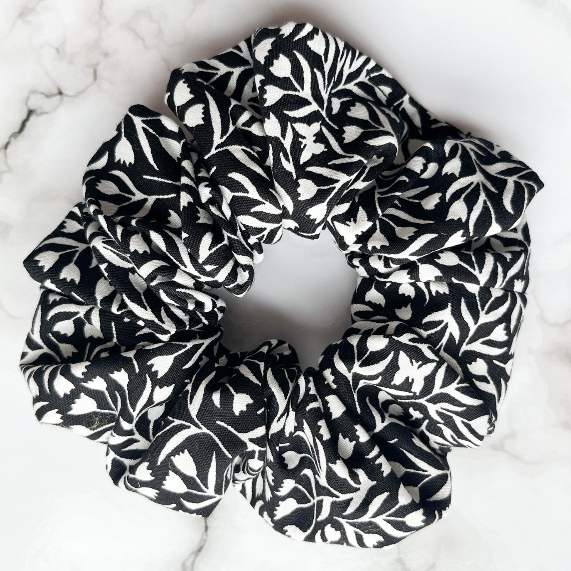 Close up of black and white floral hair scrunchie cotton E for Eva