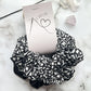 Styled tagged view of black and white floral hair scrunchies cotton velvet E for Eva
