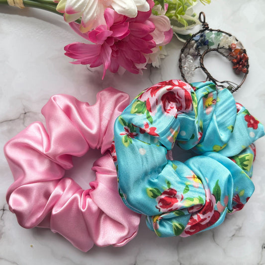 Styled overview of blue floral and pink hair scrunchies satin E for Eva
